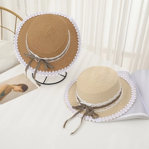 Straw sun hats with lace edges and plaid bows in beige and light brown shades