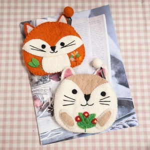 Cute felt wool animal coin purses with fox and squirrel designs on checkered background