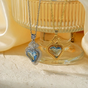 Elegant gold and silver heart necklaces with blue crystals on ribbed glass and silk