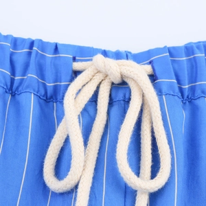 Detail of blue striped shorts waist featuring elastic band and white woven drawstring