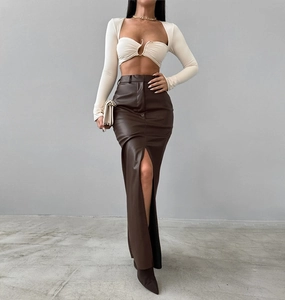 Detail of high-waisted brown faux leather maxi skirt with front slit design