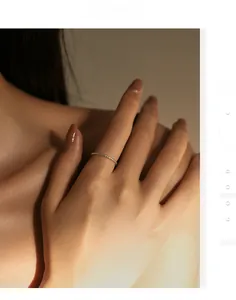 Close-up of slender gold-tone textured S925 sterling silver ring on a model's finger