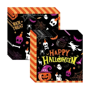 Detail showing Halloween themed paper napkins with pumpkin and witch patterns on black background
