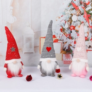Three Christmas gnomes with retractable legs in red, pink, and gray on a festive background