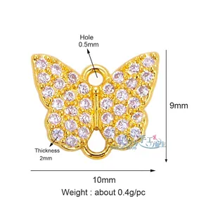 Macro detail of butterfly jewelry charm with sparkling pavé zircons and gold plating