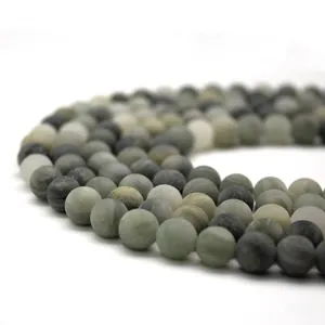 Macro shot of matte natural green grass stone beads for DIY jewelry making and bracelets