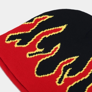 Detailed knit texture of street style beanie featuring red and yellow flame pattern
