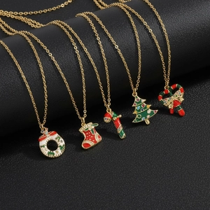 Christmas necklace collection with festive enamel pendants on black display stand