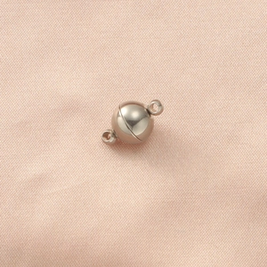 8mm silver magnetic ball clasps for DIY jewelry making on pink silk fabric background