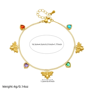 Detail of gold chain bracelet featuring bee charms and colorful heart-shaped gemstones