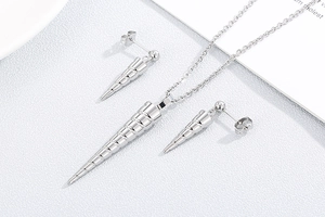 Detailed view of silver conical spiral pendant necklace and matching stud earrings set