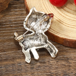 Macro shot of silver deer brooch showing its pin structure and detailed metallic texture