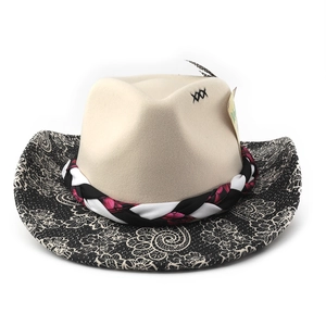 Detailed view of wide brim cowboy hat with paisley texture, embroidery, and woven band