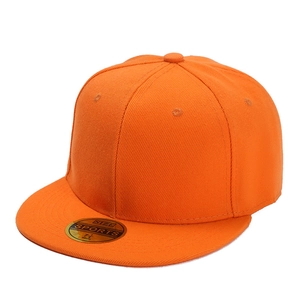 Detail view of orange flat brim baseball cap with golden size sticker on the visor