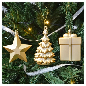 Close-up of golden star and tree ornaments hanging on a festive green Christmas tree branch
