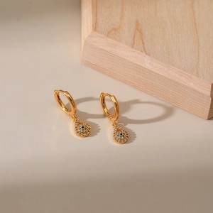 Golden drop earrings with turquoise evil eye design and white zircon stones