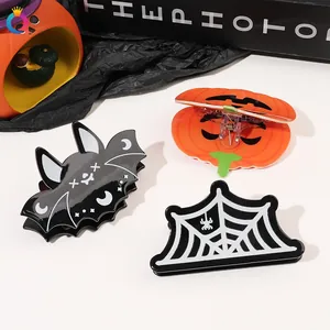 Detail of Halloween hair claw clips set featuring bat, pumpkin, and spider web designs
