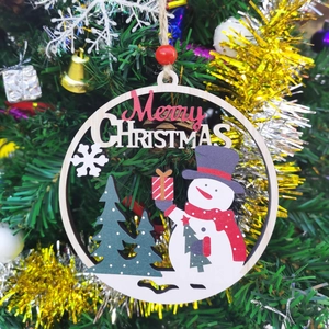 Detail of wooden Christmas ornaments hanging on a tree with Merry Christmas text
