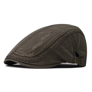 Detail of embroidered logo and adjustable metal buckle on dark brown cotton beret hat