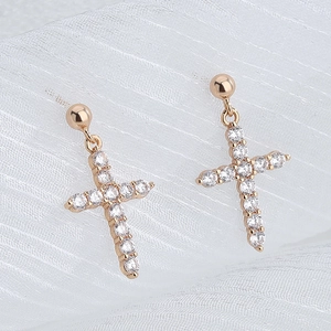Macro detail of French Baroque S925 silver cross earrings with sparkling pavé zircons