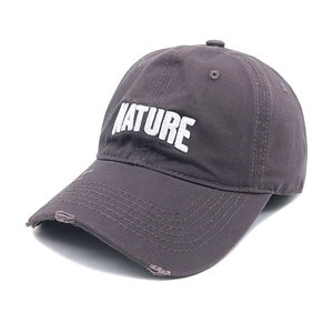 Close-up of NATURE 3D embroidery and distressed brim on vintage washed cotton baseball cap