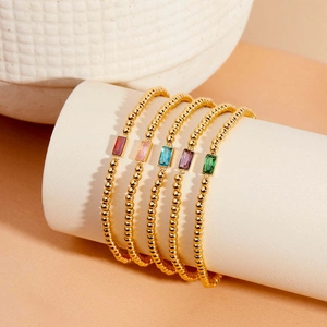 Luxury gold beaded bracelets set featuring colorful rectangle birthstone charms on display