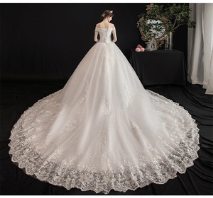 Exquisite white off-shoulder wedding gown with cathedral train and intricate lace embroidery
