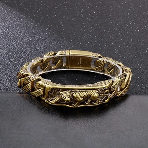 Detail of vintage gold tiger relief on stainless steel hip hop chain for men