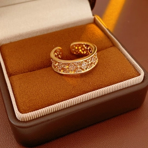 Detailed view of gold plated hollow flower ring with zircon in a velvet jewelry box