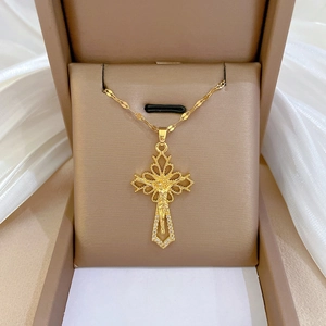 Titanium steel cross necklace with Jesus relief and diamonds in a beige jewelry box