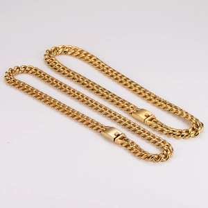 Detailansicht goldener Panzerketten aus Edelstahl mit Kastenverschluss auf Weiß