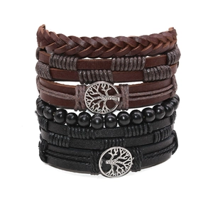 Detail of 5-piece braided leather bracelet set with tree of life charms and beads