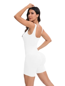 Close-up detail of white ribbed seamless yoga bodysuit showing texture and back silhouette