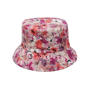 Detail of floral bucket hat featuring vibrant pink and coral abstract patterns with stitching