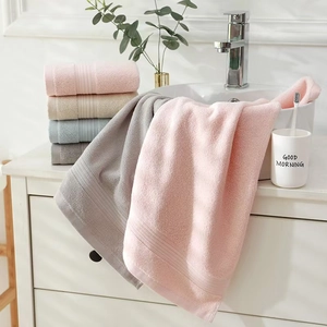 Close-up of fluffy 100% cotton towels in pastel pink, beige, blue and grey colors