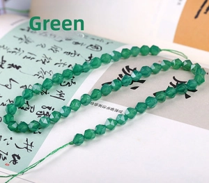 Macro view of faceted hexagonal green agate beads on a classic calligraphy background