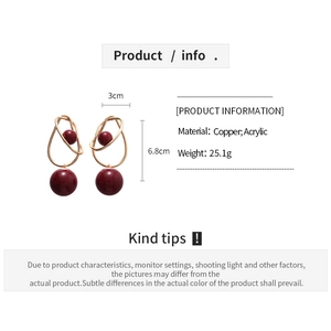 Detailed view of red acrylic ball earrings with gold twisted copper and size dimensions