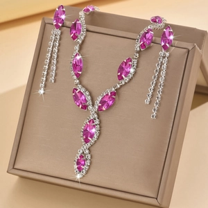 Close-up of pink marquise crystal jewelry set with sparkling rhinestone fringe details