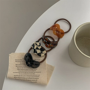 Acetate elastic hair ties set in orange, amber, plaid, and black with handmade engraving