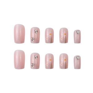Pink press-on nails with silver glitter, rhinestones and white daisy floral patterns