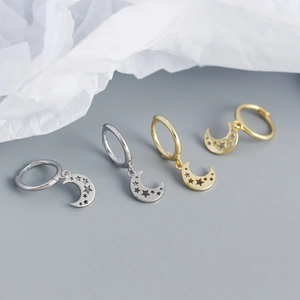 Detail of s925 silver moon and star cutout hoop earrings in gold and silver finish