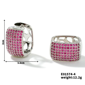 Detail of silver quadrilateral hoop earrings with pink zircons and heart cut-outs