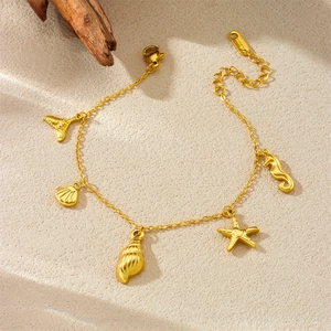 Gold stainless steel bracelet featuring starfish, shell, and mermaid tail charms