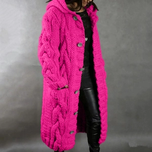 Detail view of pink cable knit texture on a long hooded cardigan with large buttons