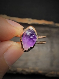 Close-up of vintage copper ring featuring an irregular raw purple crystal stone