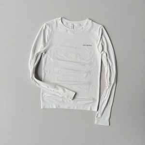 Detail of white long sleeve yoga top featuring thumb holes and high-elastic fabric texture