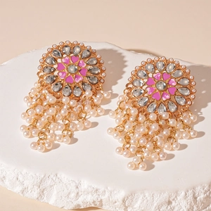 Detail of French vintage earrings featuring pink enamel hearts and pearl tassels