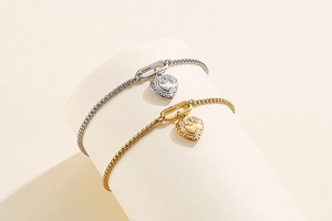 Detail of gold and silver heart bracelets with Venetian chain on a jewelry display