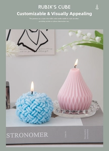 Close-up of geometric scented candles with blue knot and pink cone shapes on glass tray