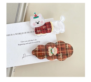 Detail of cute acrylic dog and red plaid cloud hair clips on a decorative card